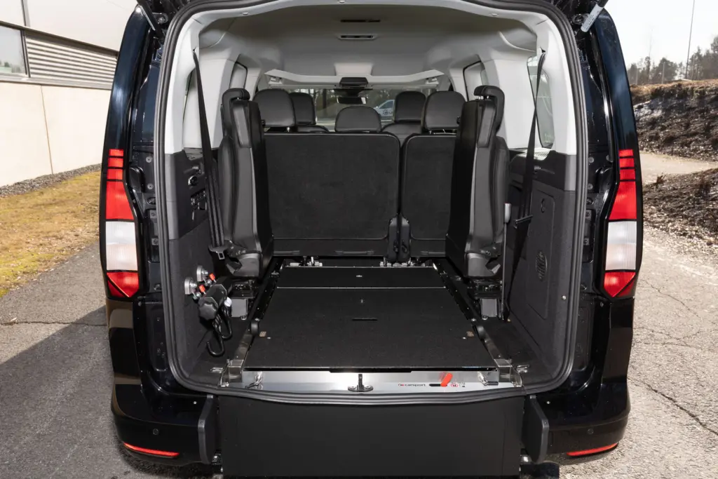 Musta Volkswagen Caddy XXL Plus jonka invaramppi on käännetty tasalattiaksi.